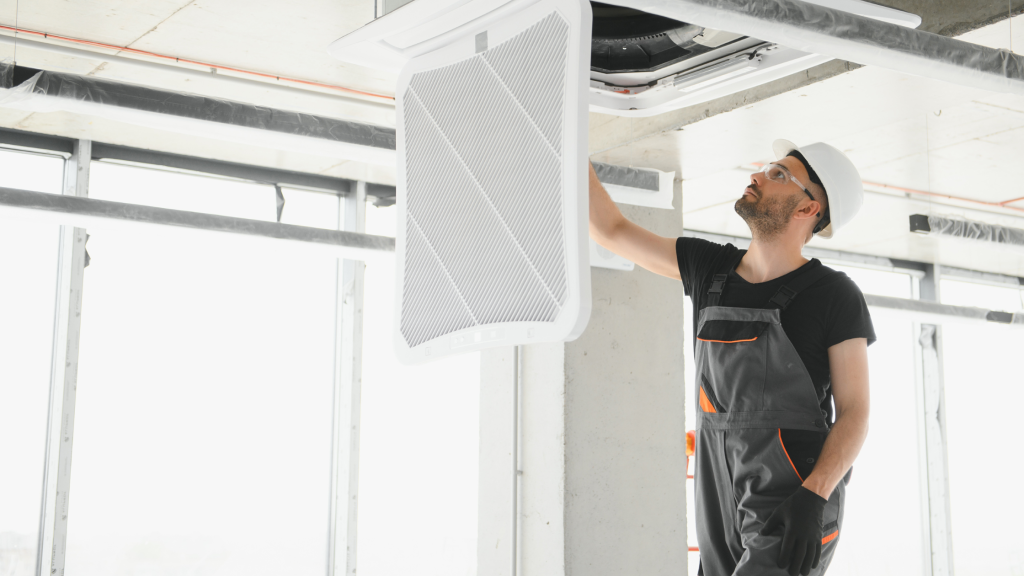 Cold Room Installations Your Complete Guide worker installing cooling fan for cold room storage